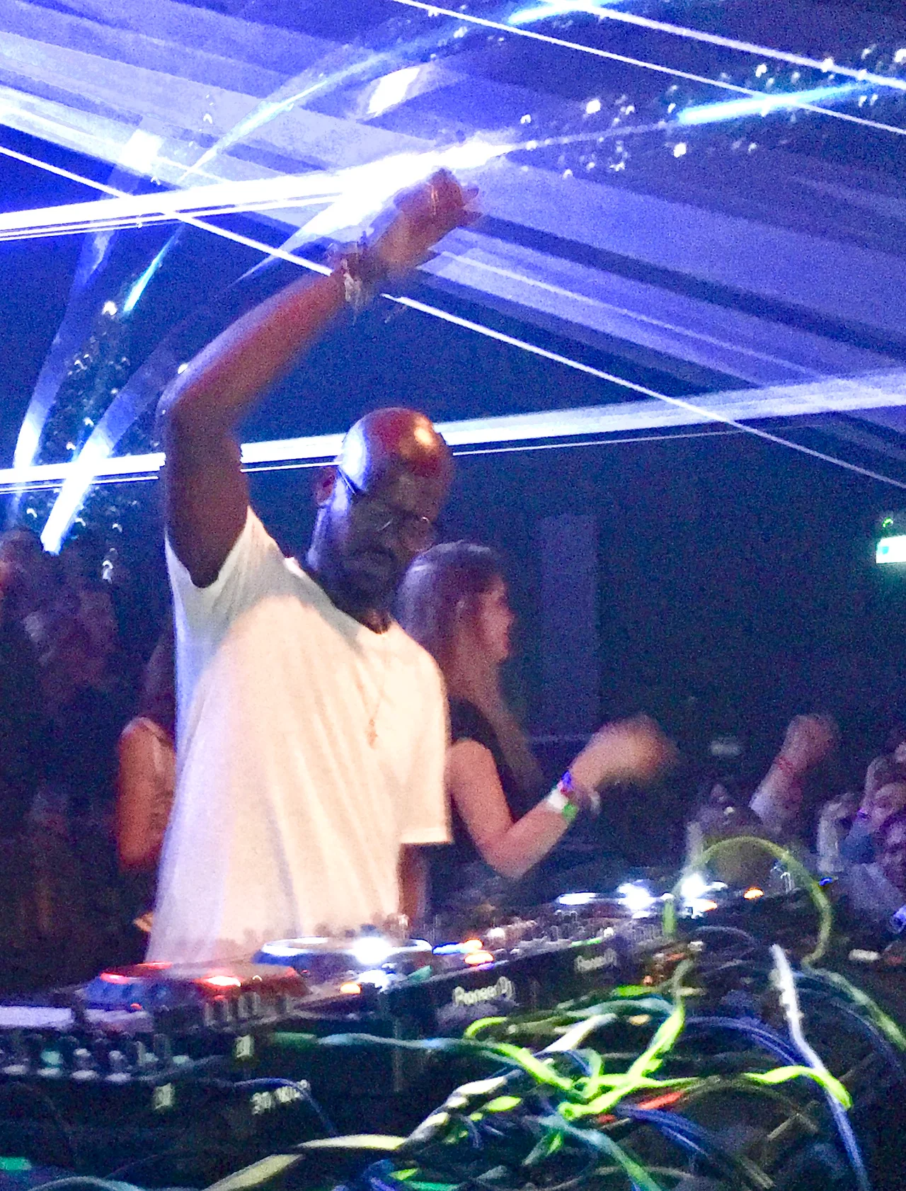 Black Coffee performing behind the decks under blue lighting at Hï Ibiza