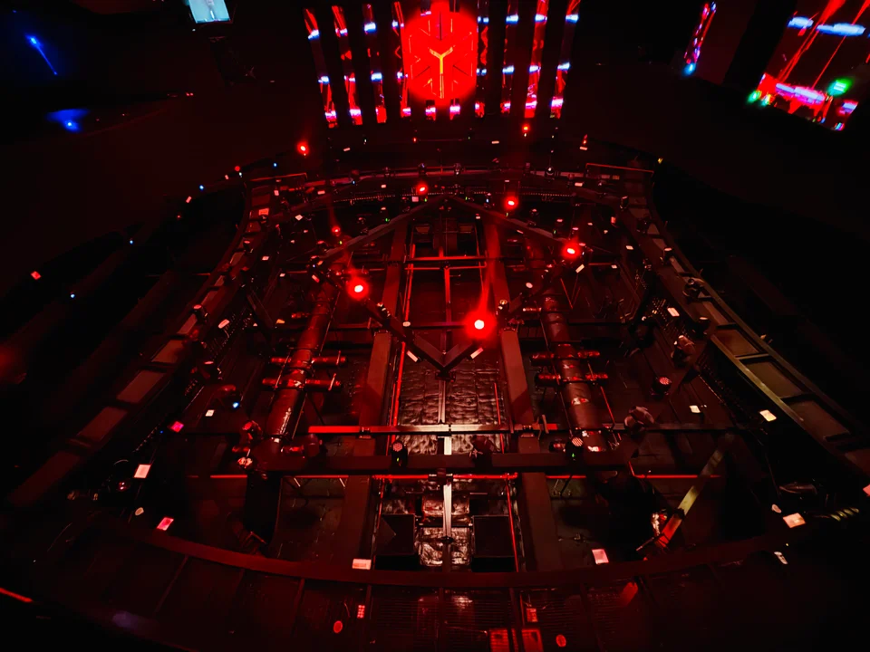 Red lighting and overhead rigging inside WHITE Abu Dhabi